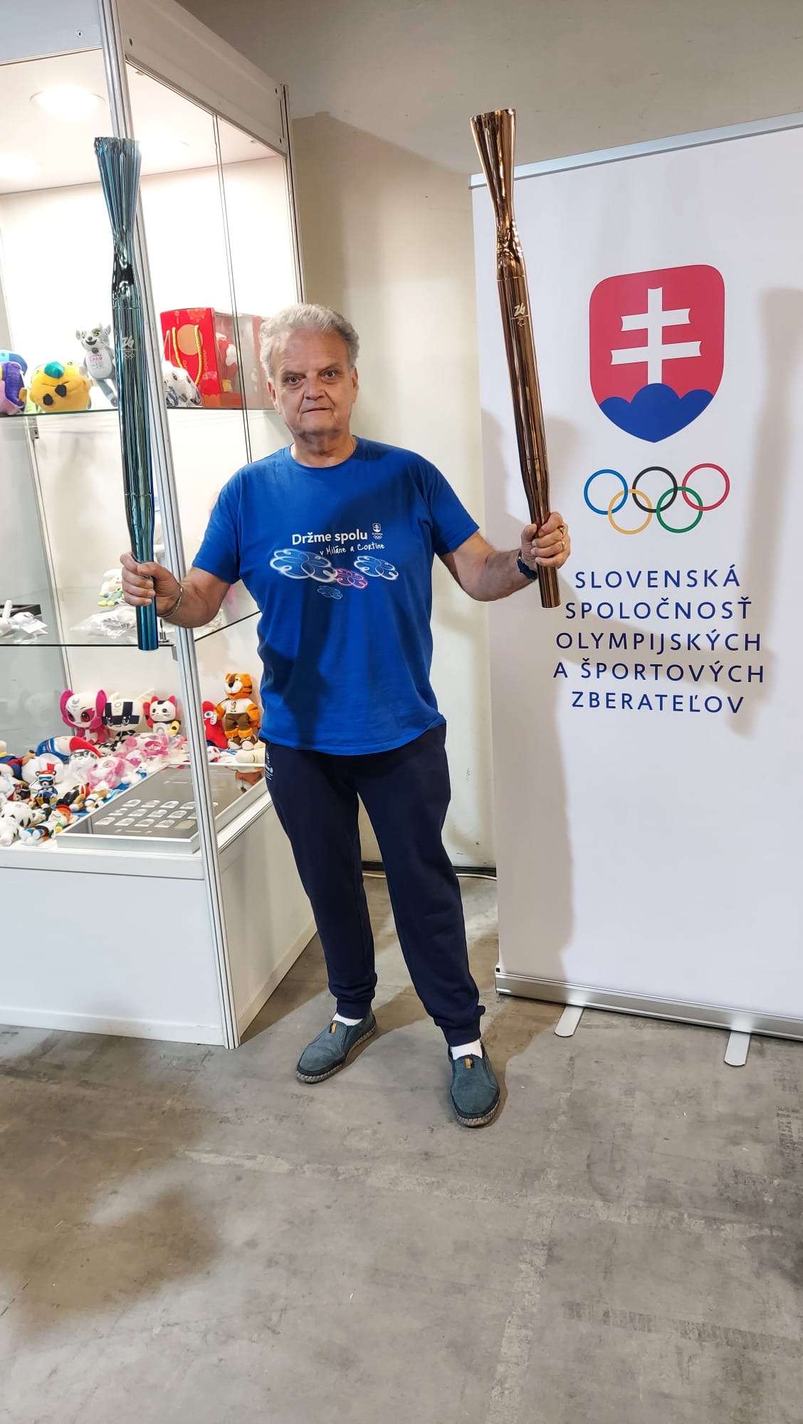 Velimir Adžić with torches from the Milano Cortina 2026 Olympic and Paralympic Games.